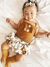 Load image into Gallery viewer, Baby onesie bodysuit has a cute ruffle detail and front buttons and spaghetti straps and skirted bloomers