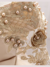 Load image into Gallery viewer, Baby dress has a satin embroidered bodice with pearl details and capped sleeves, a bow belt at the waist, and a tulle skirt with flower applique