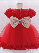 Load image into Gallery viewer, Baby dress has a floral bodice, a tulle skirt with floral hem, and a gold sequin belt with bow at the front and back