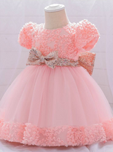 Load image into Gallery viewer, Baby dress has a floral bodice, a tulle skirt with floral hem, and a gold sequin belt with bow at the front and back