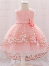 Load image into Gallery viewer, Baby dress has embroidered tulle overlay bodice and hi-lo tulle overlay skirt, removable big bow accent at the back and flower applique at the front