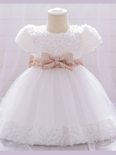 Load image into Gallery viewer, Baby dress has a floral bodice, a tulle skirt with floral hem, and a gold sequin belt with bow at the front and back