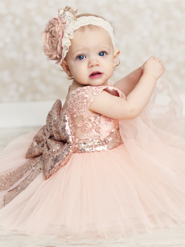 Baby tutu dress has an embroidered floral bodice, a sequin belt at the waistline with a big bow at the back, and a tutu skirt