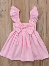 Load image into Gallery viewer, Baby apron style dress has a ruffled adjustable straps and a stretchy bodice with a big bow
