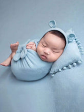 Load image into Gallery viewer, Baby features a shawl - wrap that has knots in the front with a cap with ears and a little pillow - blue
