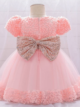 Load image into Gallery viewer, Baby dress has a floral bodice, a tulle skirt with floral hem, and a gold sequin belt with bow at the front and back
