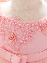Load image into Gallery viewer, Baby dress has a satin embroidered bodice with pearl details and capped sleeves, a bow belt at the waist, and a tulle skirt with flower applique
