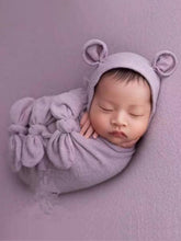 Load image into Gallery viewer, Baby features a shawl - wrap that has knots in the front with a cap with ears and a little pillow - taupe
