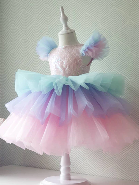 Girls  dress has a sequin bodice with ruffled shoulders and a cute layered tutu skirt Includes: dress