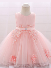 Load image into Gallery viewer, Baby dress has a tulle overlay with flower applique and a satin belt with rhinestone detail-pink
