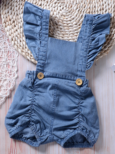 Baby overall style romper onesie has ruffled shoulder straps that tie on the back. has 2 little buttons on the front to make it even more stylish