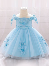 Load image into Gallery viewer, Baby dress has a satin embroidered bodice with pearl details and capped sleeves, a bow belt at the waist, and a tulle skirt with flower applique
