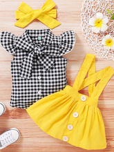 Load image into Gallery viewer, Baby set features a plaid top with front buttons and bow at the color, a skirt with cute suspenders, and a matching headband
