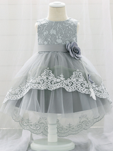 Load image into Gallery viewer, Baby dress has embroidered tulle overlay bodice and hi-lo tulle overlay skirt, removable big bow accent at the back and flower applique at the front
